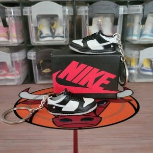 Nike Pair of mini sneakers keychain.